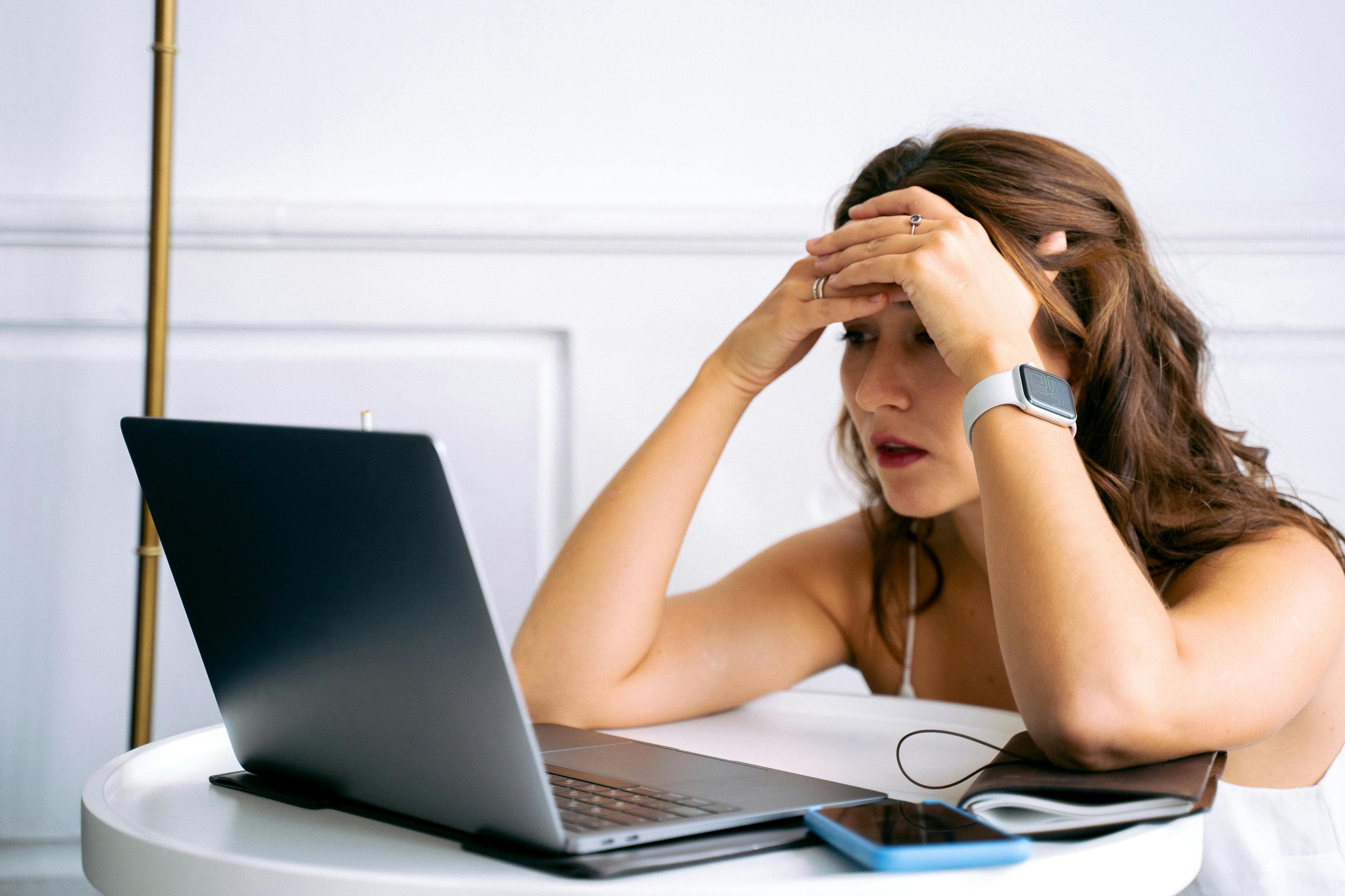 Woman staring at a laptop computer in frustration.